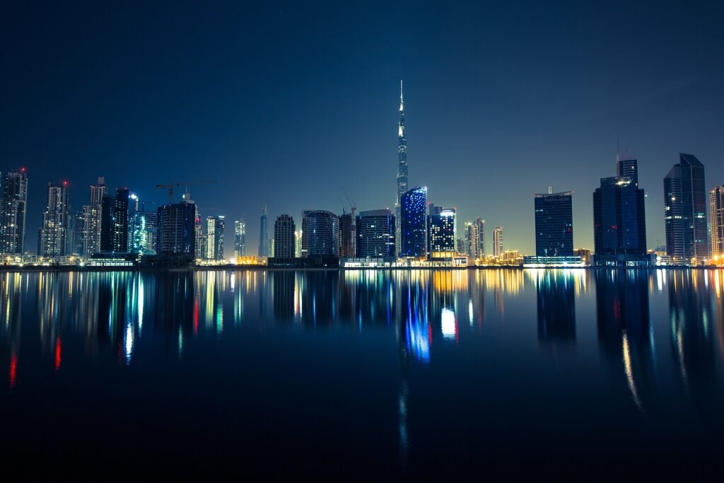 Dubai skyline at night reflected in the water, United Arab Emirates